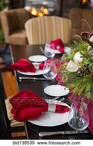 Stock Photo - Christmas table and centerpiece in dining room. Fotosearch