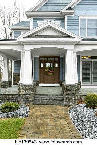 Stock Image - Christmas wreath on front door of house. Fotosearch