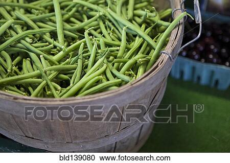 Stock Image - Close up of basket of fresh green beans. Fotosearch