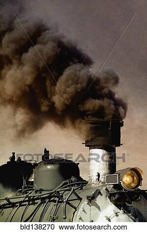 Stock Image - Close up of billowing smoke stack on train. Fotosearch