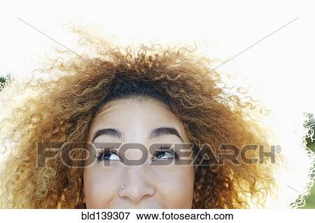 Stock Photo - Close up of Hispanic woman looking up. Fotosearch