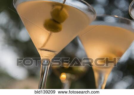 Stock Photo - Close up of martinis with olives. Fotosearch