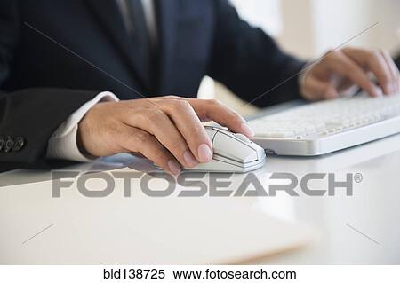 Close up of mixed race businessman using wireless mouse and keyboard View Large Photo Image Stock Photography - Close up of mixed race businessman using wireless mouse and keyboard. Fotosearch