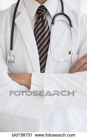 Close up of mixed race doctor with arms crossed View Large Photo Image Stock Image - Close up of mixed race doctor with arms crossed. Fotosearch