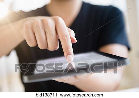 Close up of mixed race man using digital tablet View Large Photo Image Stock Image - Close up of mixed race man using digital tablet. Fotosearch