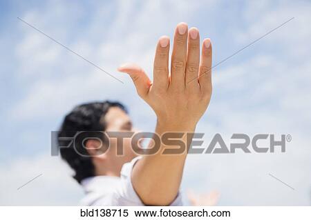 Stock Photography - Close up of mixed race man with arms outstretched. Fotosearch
