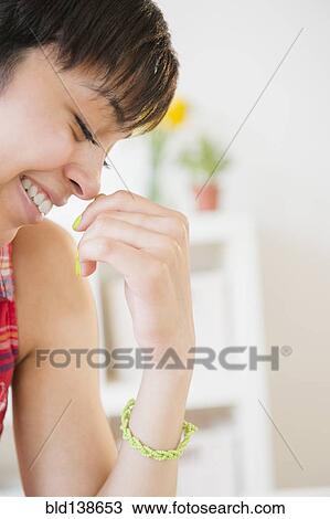 Stock Image - Close up of mixed race woman smiling. Fotosearch