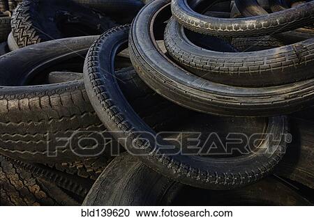 Stock Image - Close up of piles of discarded tires. Fotosearch
