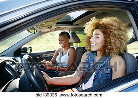 Daughter driving mother in car View Large Photo Image Stock Photograph - Daughter driving mother in car. Fotosearch