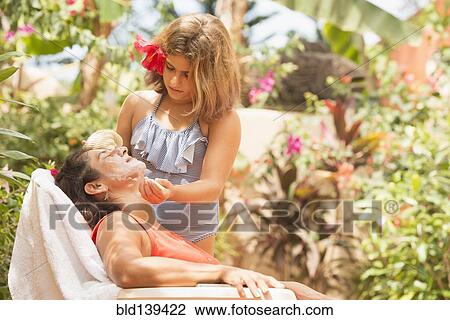 Daughter putting sunscreen on mothers face View Large Photo Image Stock Image - Daughter putting sunscreen on mothers face. Fotosearch