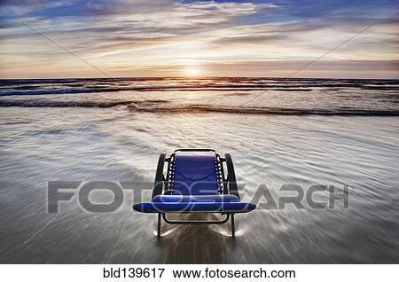 Deck chair overlooking sunset on beach View Large Photo Image Stock Photo - Deck chair overlooking sunset on beach. Fotosearch