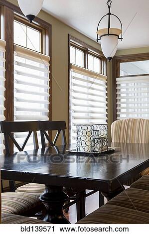 Stock Image - Dining table and chairs in dining room. Fotosearch