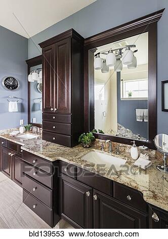 Double sinks, mirror and cabinets in modern bathroom View Large Photo Image Stock Image - Double sinks, mirror and cabinets in modern bathroom. Fotosearch