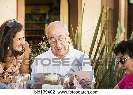 Family reading menu at cafe View Large Photo Image Stock Image - Family reading menu at cafe. Fotosearch