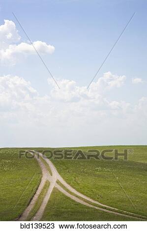 Stock Image - Forked dirt road in remote landscape. Fotosearch