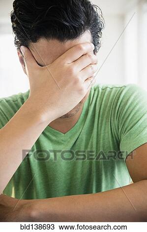 Frustrated mixed race man covering his face View Large Photo Image Stock Image - Frustrated mixed race man covering his face. Fotosearch