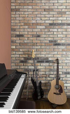 Guitars and piano near brick wall View Large Photo Image Stock Photography - Guitars and piano near brick wall. Fotosearch