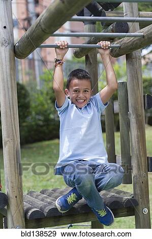 Stock Photo - Hispanic boy playing at playground. Fotosearch