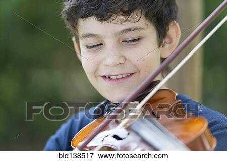Stock Photo - Hispanic boy playing violin. Fotosearch