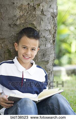 Hispanic boy reading book View Large Photo Image Stock Image - Hispanic boy reading book. Fotosearch