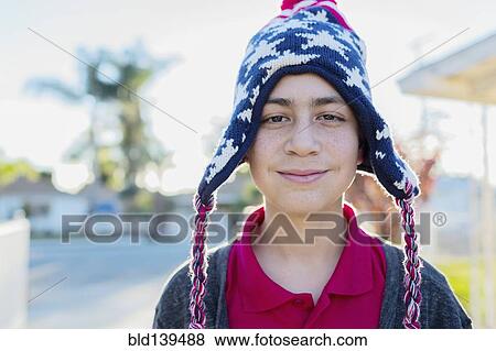 Stock Photo - Hispanic boy wearing knit cap outdoors. Fotosearch