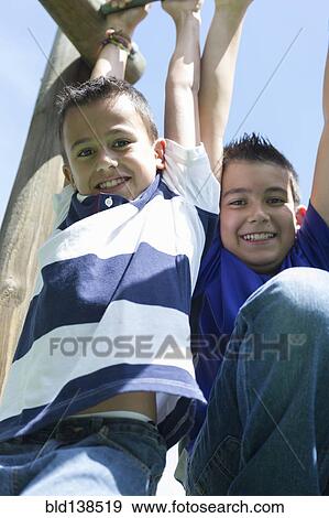 Stock Photo - Hispanic boys playing at playground. Fotosearch