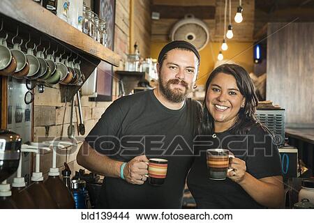 Hispanic couple working in coffee shop View Large Photo Image Picture - Hispanic couple working in coffee shop. Fotosearch
