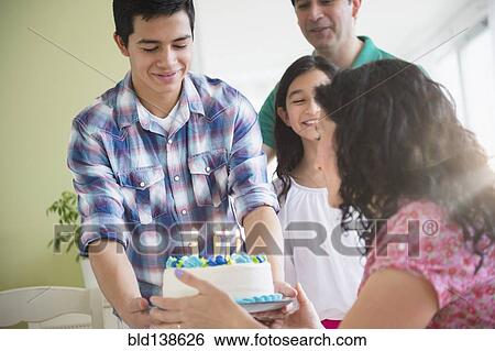 Stock Photograph - Hispanic family celebrating birthday together. Fotosearch