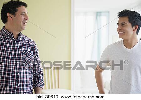 Stock Photo - Hispanic father and son talking. Fotosearch