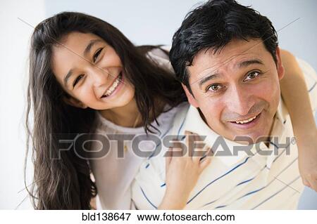 Hispanic father carrying daughter piggyback View Large Photo Image Stock Photo - Hispanic father carrying daughter piggyback. Fotosearch