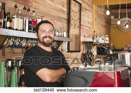 Hispanic man working in coffee shop View Large Photo Image Stock Image - Hispanic man working in coffee shop. Fotosearch