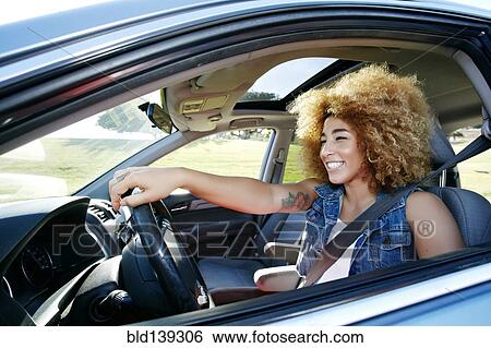 Stock Photograph - Hispanic woman driving car. Fotosearch