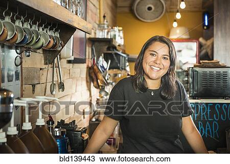 Hispanic woman working in coffee shop View Large Photo Image Stock Image - Hispanic woman working in coffee shop. Fotosearch
