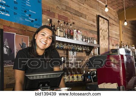 Stock Photo - Hispanic woman working in coffee shop. Fotosearch