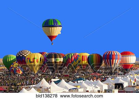 Hot air balloon floating above others at festival, Albuquerque, New Mexico, United States View Large Photo Image Stock Photo - Hot air balloon floating above others at festival, Albuquerque, New Mexico, United States. Fotosearch