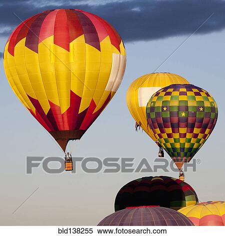 Stock Photography - Hot air balloons floating in blue sky. Fotosearch