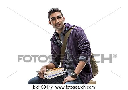 Indian student holding stack of books View Large Photo Image Stock Photo - Indian student holding stack of books. Fotosearch