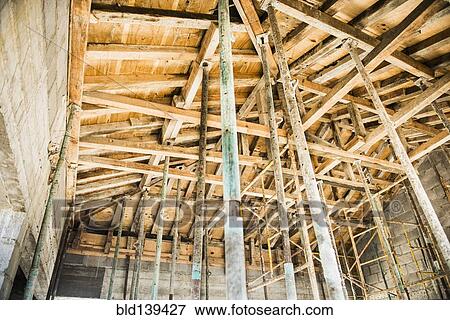 Stock Photo - Low angle view of wooden house frame. Fotosearch