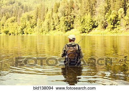 Mari fisherman holding fishing rod in lake View Large Photo Image Picture - Mari fisherman holding fishing rod in lake. Fotosearch