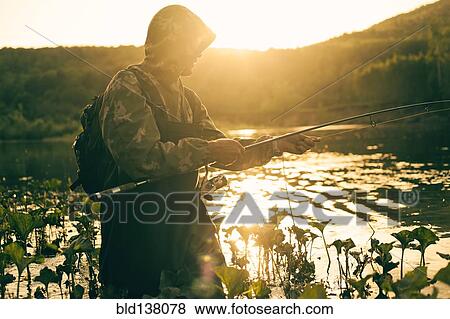 Stock Photo - Mari man fishing in lake. Fotosearch