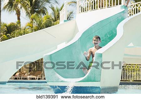 Mixed race boy laughing on water slide View Large Photo Image Stock Image - Mixed race boy laughing on water slide. Fotosearch