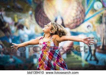 Mixed race girl dancing near urban rural View Large Photo Image Stock Image - Mixed race girl dancing near urban rural. Fotosearch