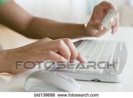 Mixed race man shopping online with credit card View Large Photo Image Stock Photo - Mixed race man shopping online with credit card. Fotosearch