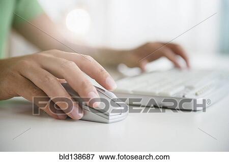 Mixed race man using wireless mouse and keyboard View Large Photo Image Stock Photo - Mixed race man using wireless mouse and keyboard. Fotosearch