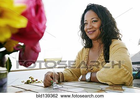 Mixed race woman drinking wine at waterfront View Large Photo Image Stock Image - Mixed race woman drinking wine at waterfront. Fotosearch