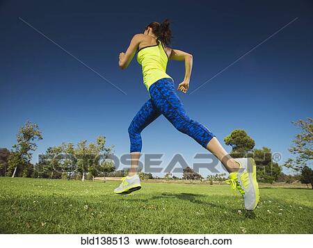Mixed race woman jogging in park View Large Photo Image Stock Image - Mixed race woman jogging in park. Fotosearch