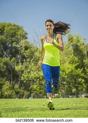 Mixed race woman jogging in park View Large Photo Image Stock Photograph - Mixed race woman jogging in park. Fotosearch