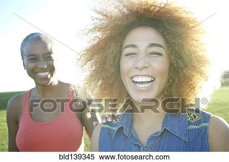 Stock Photography - Mother and daughter smiling outdoors. Fotosearch