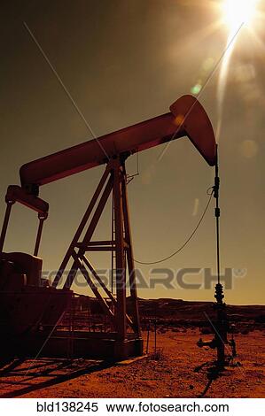 Oil pump drilling in remote field View Large Photo Image Stock Photography - Oil pump drilling in remote field. Fotosearch
