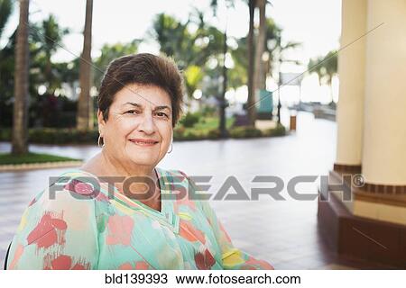 Older woman smiling outdoors View Large Photo Image Stock Image - Older woman smiling outdoors. Fotosearch